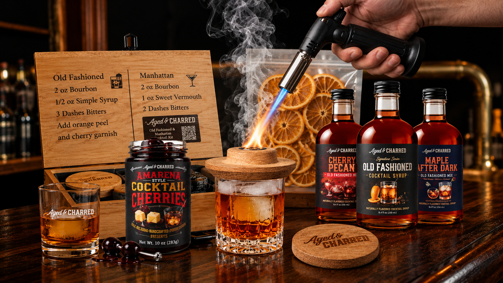 Whiskey lover's gift basket with a cocktail smoker, torch, syrups, cherries, and Old Fashioned cocktails